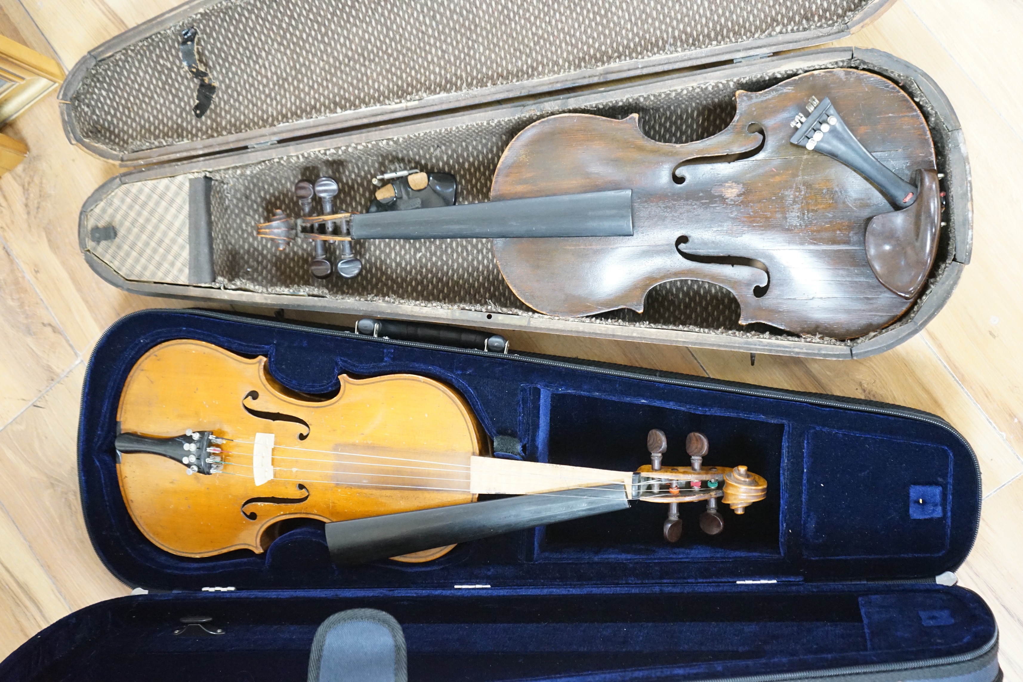 Two cased unnamed violins